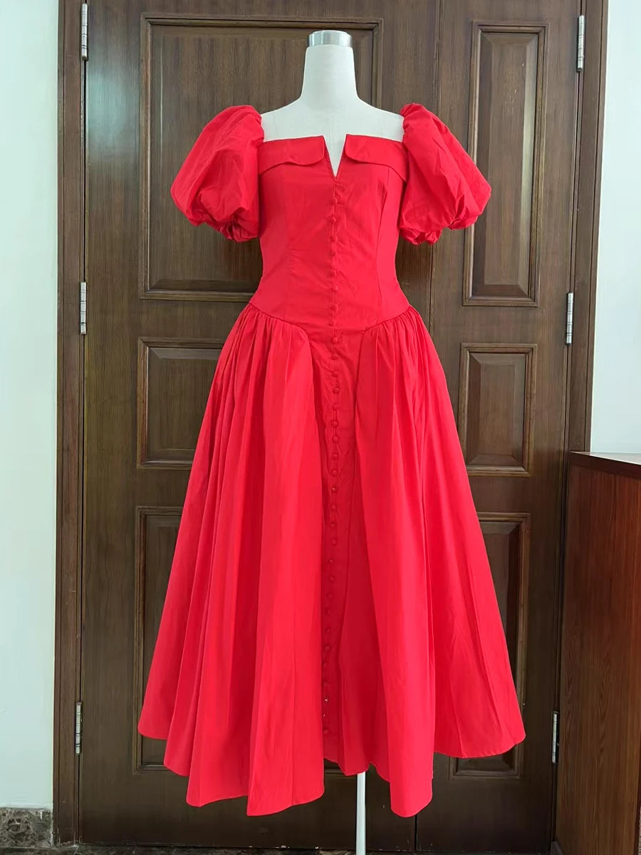 Red dress on a mannequin against a wooden door background