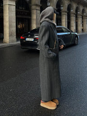 Women's long coat with a striped pattern and oversized fit.