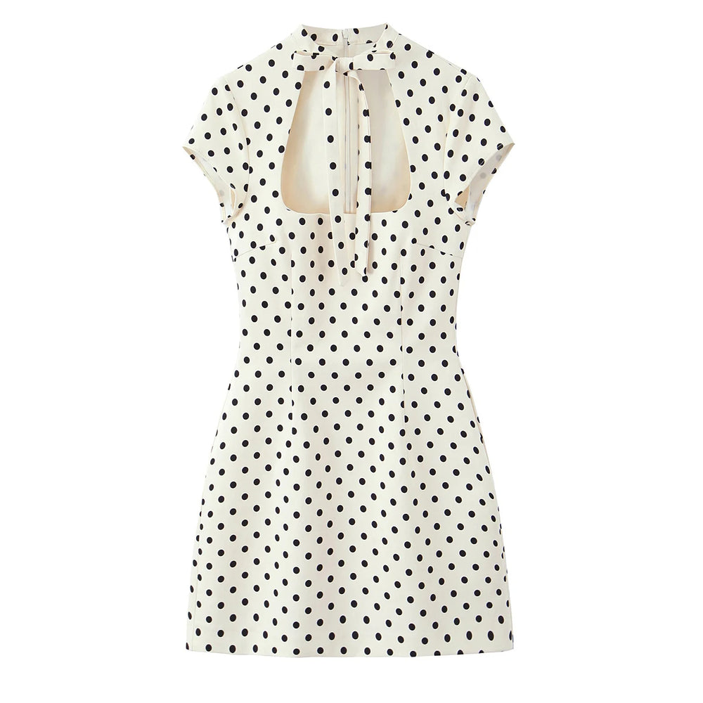 White dress with black polka dots on a white background