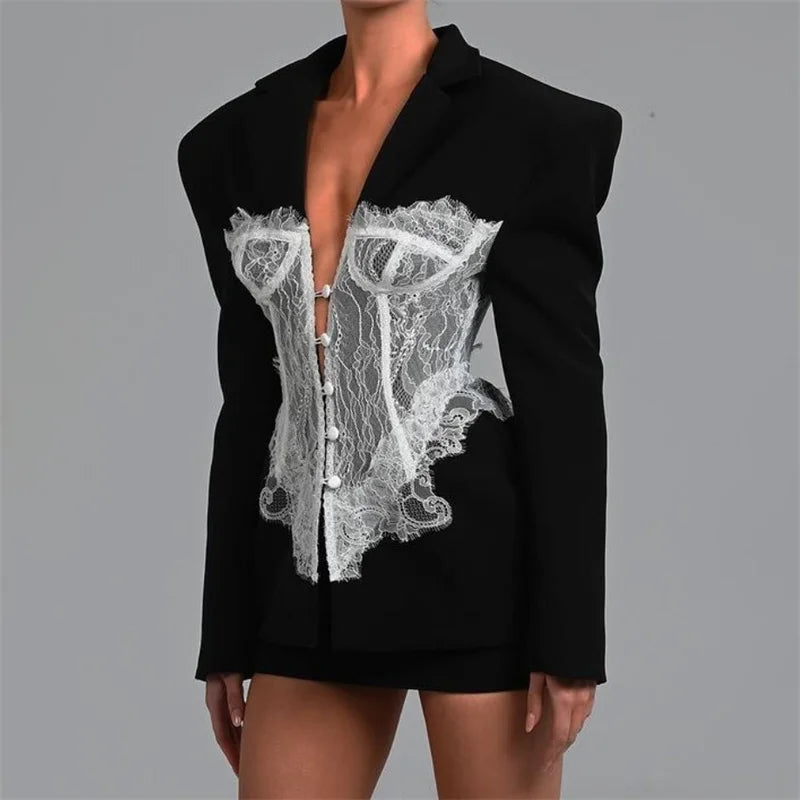 Black blazer with white lace detailing on a gray background