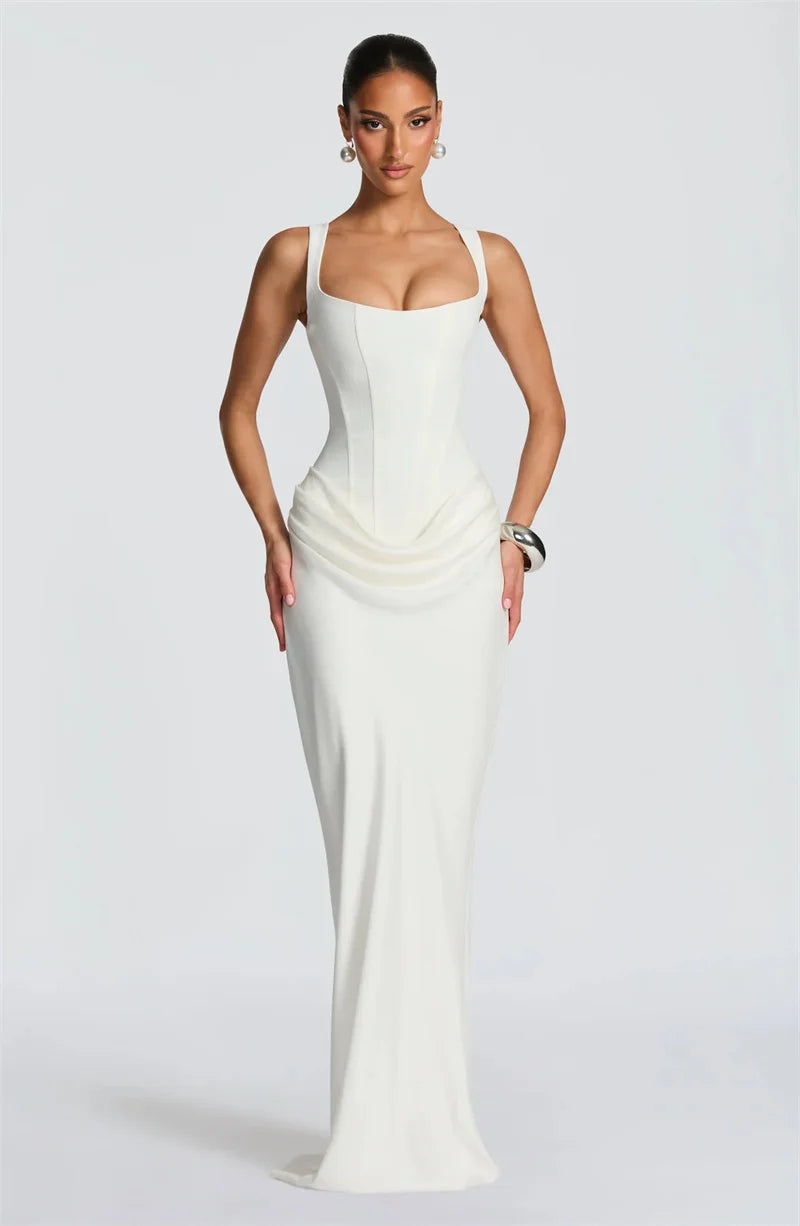 Woman wearing a white evening gown on a plain background