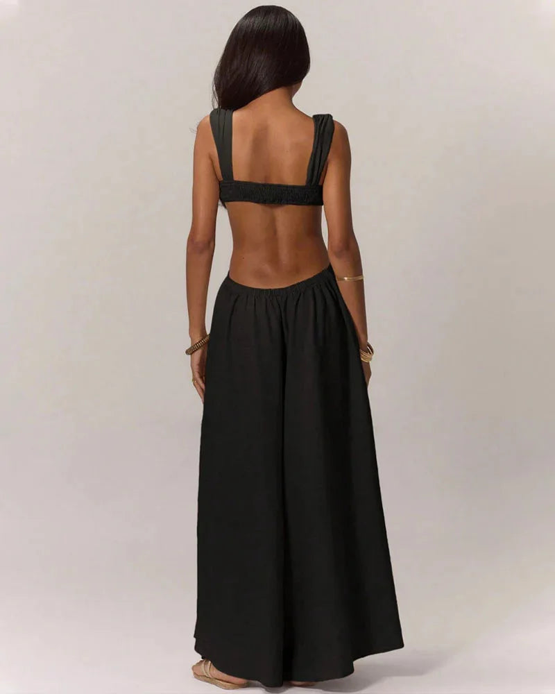 Black jumpsuit with open back worn by a person on a plain background