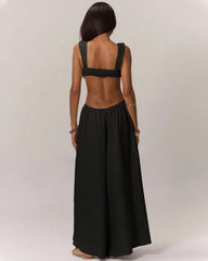 Black jumpsuit with open back worn by a person on a plain background