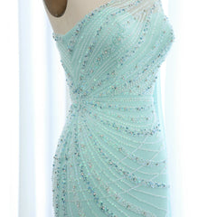  A glamorous turquoise mermaid evening gown with a flowing feather cape and one-shoulder neckline. Golden Atelier 3