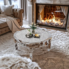 Round mirrored coffee table in a living room with a fireplace.