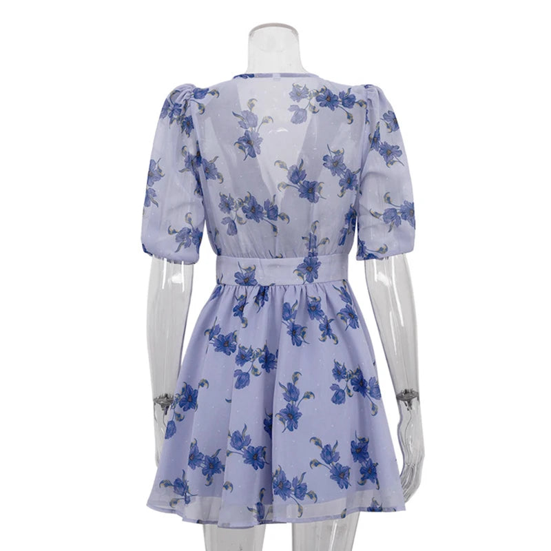 White dress with blue floral pattern on a mannequin against a white background