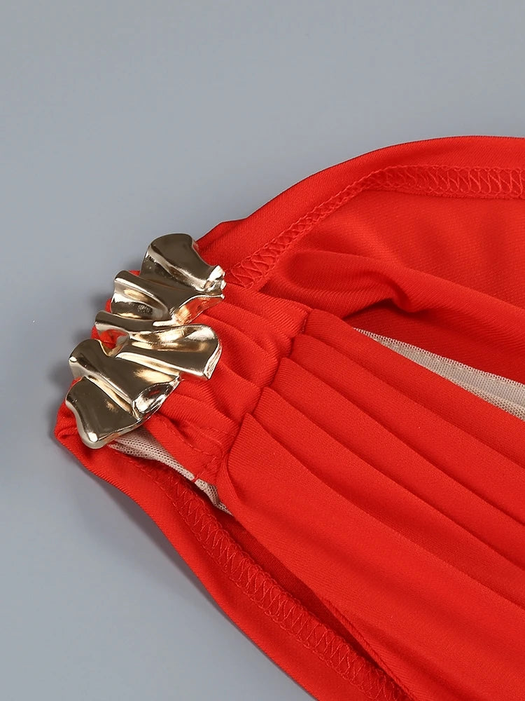 Red fabric with gold decorative elements on a gray background