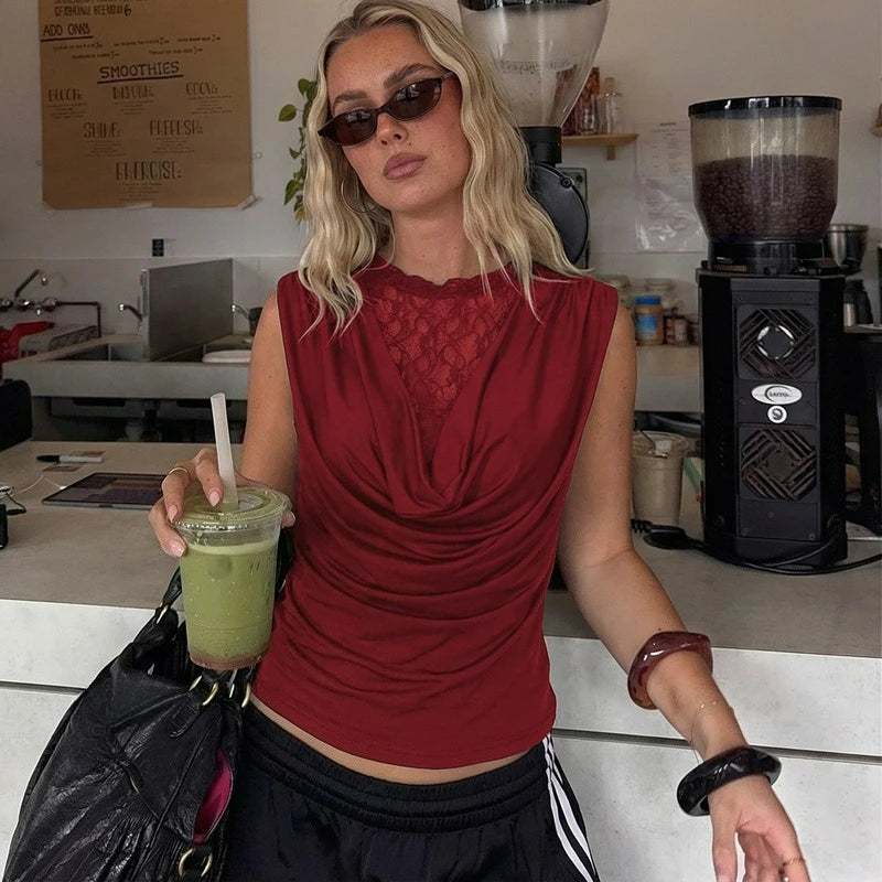 Woman in a red top holding a green smoothie in a kitchen setting