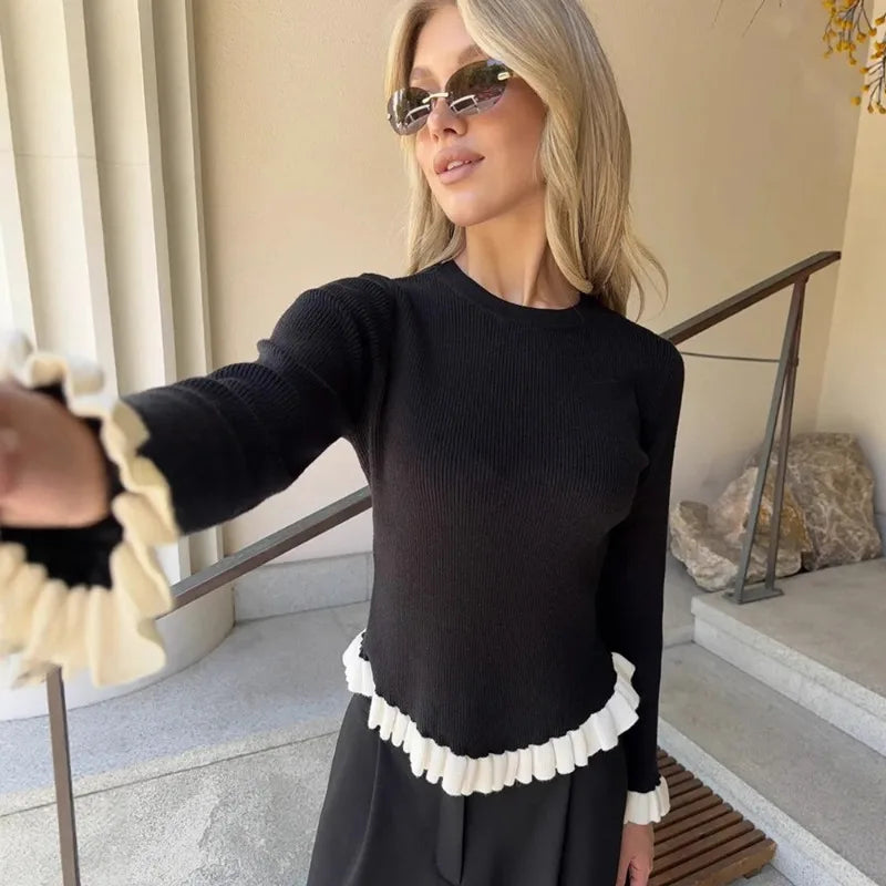 Model wearing ribbed knit top with ruffled trim