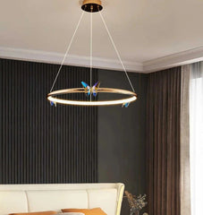Modern chandelier hanging in a living room with a neutral color scheme.
