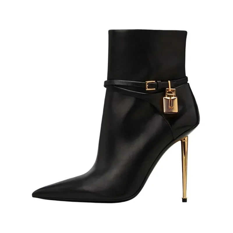 Black leather pointed toe ankle boots with gold lock and buckle detail