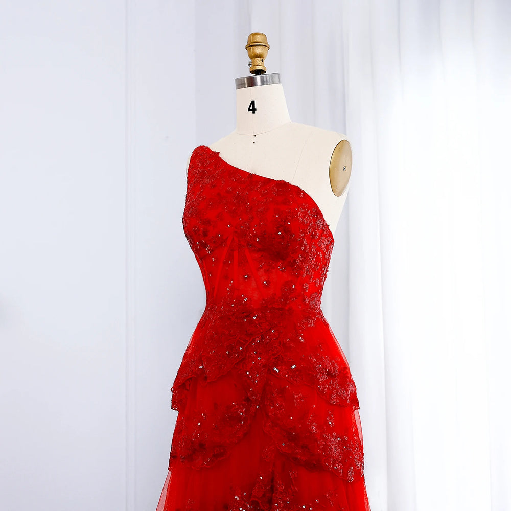 Red one-shoulder dress on a mannequin against a white background