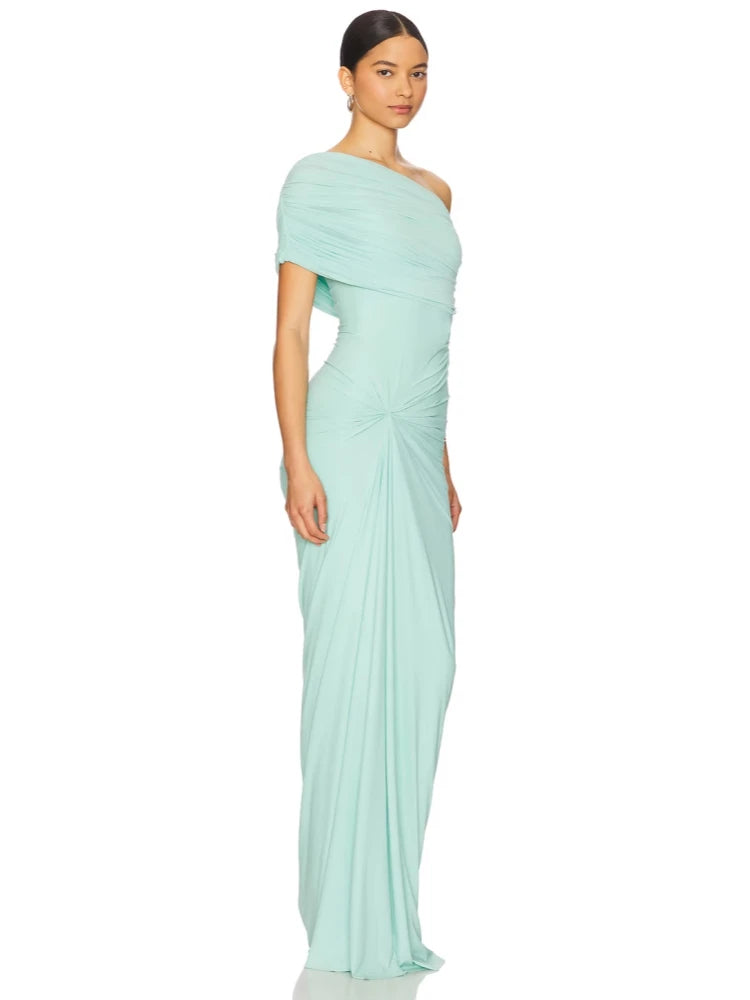 Woman wearing a light blue one-shoulder dress on a white background