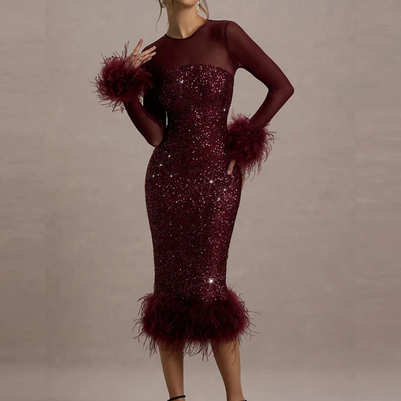 Red sequin dress with feathered sleeves on a plain background