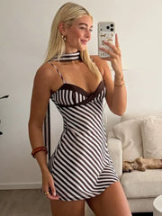 Model wearing a striped halter neck mini dress indoors