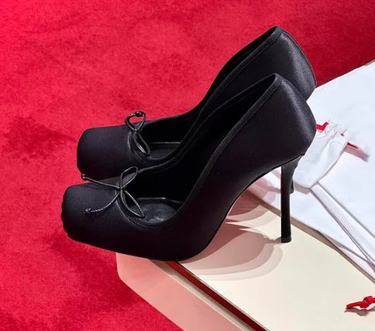 Black square toe thin heel pumps with bow detail