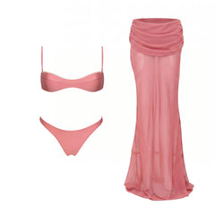 Pink ribbed bikini top and bottoms next to a pink sheer draped maxi skirt