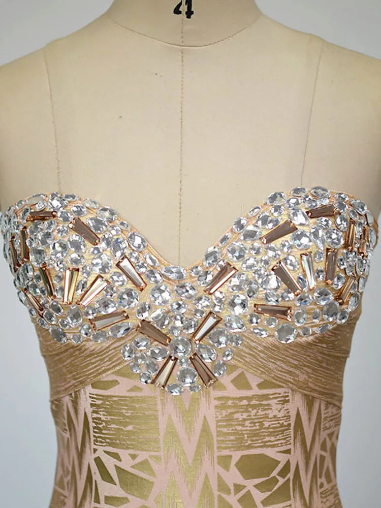 Mannequin wearing a dress with a decorative top featuring crystals and gold accents.