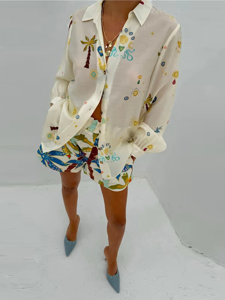 Person wearing a colorful patterned outfit with a white shirt and shorts on a plain background