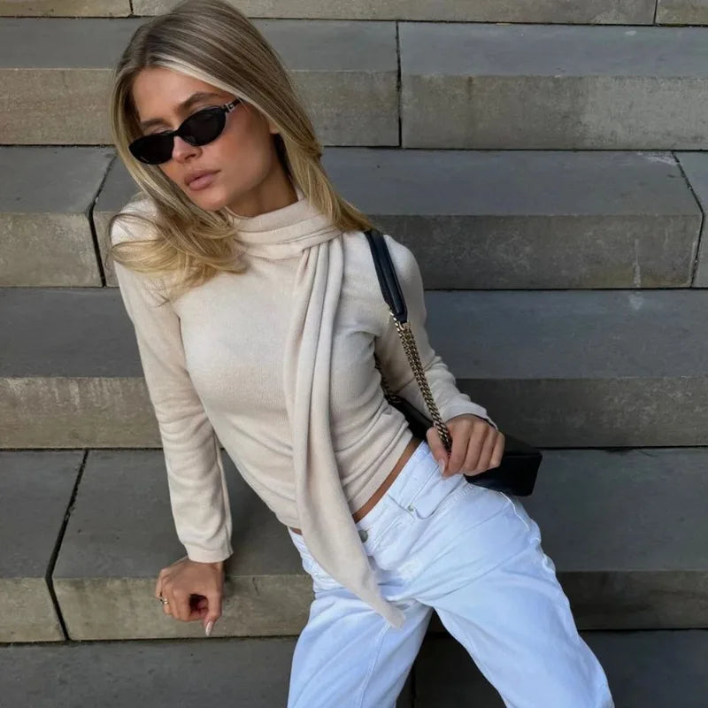 Cream knit top with scarf neck detail seated view