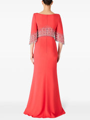 Red evening gown with beaded sleeves on a white background