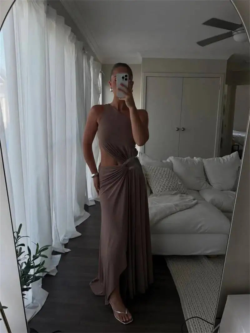 Mirror selfie of a person in a one shoulder cutout maxi dress