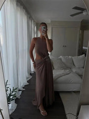 Mirror selfie of a person in a one shoulder cutout maxi dress