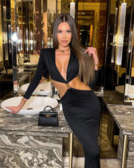 Woman in a black dress posing in an elegant interior setting