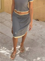 Model wearing grey midi skirt with side split