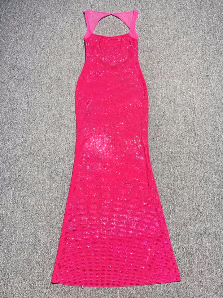 Pink dress with cutout back on a gray surface