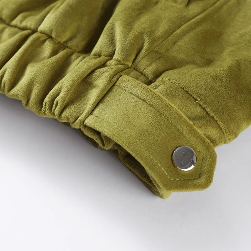Close-up of a green jacket sleeve with a button 