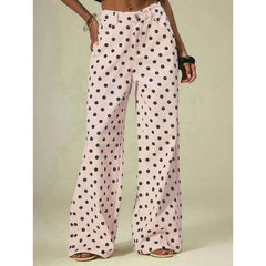 Polka dot pants worn by a person on a plain background