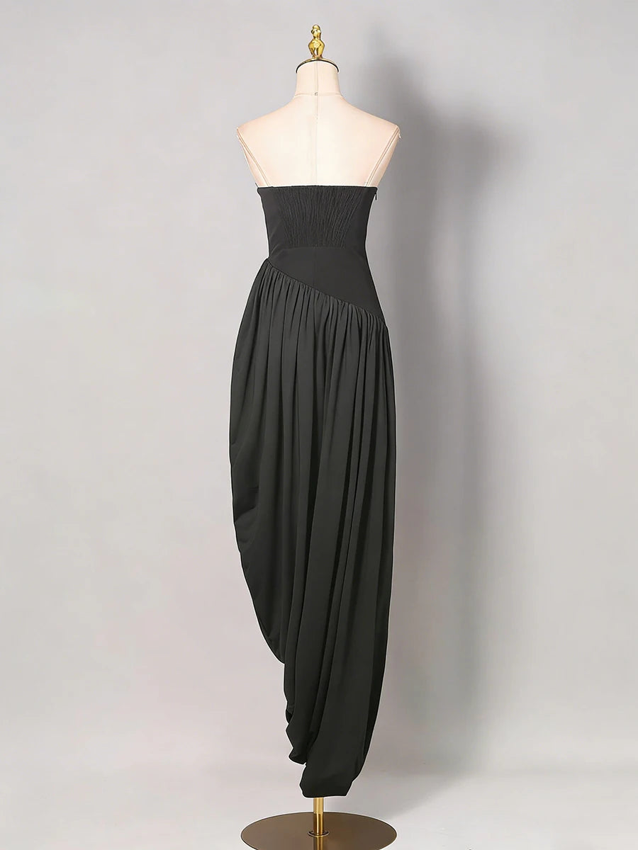 Black strapless dress on a mannequin against a plain background