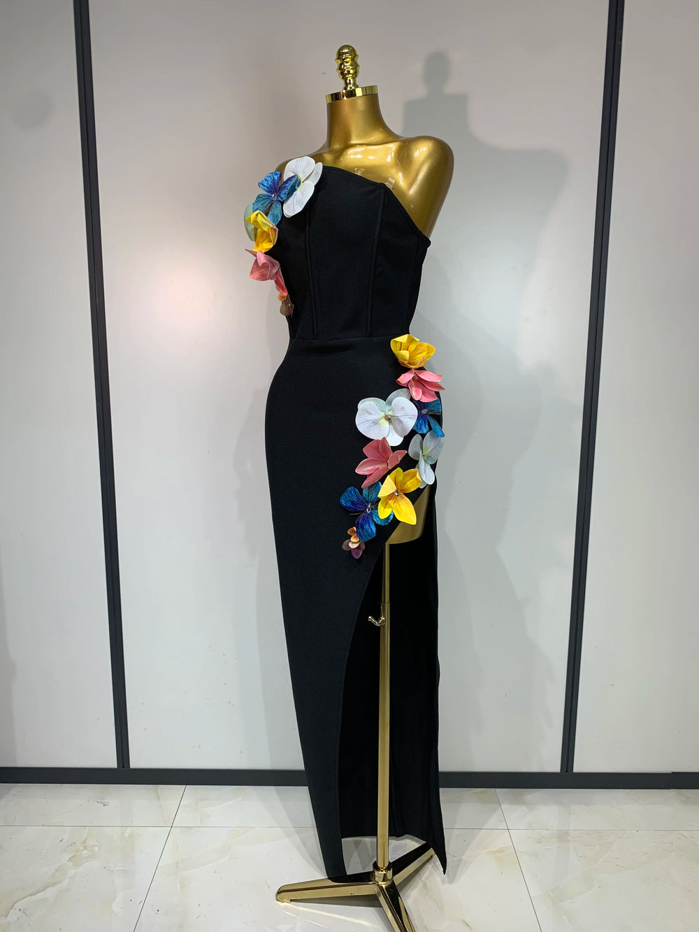 Close-up of floral appliqués on a black strapless dress