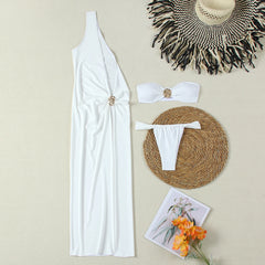 Flat lay of a white solid maxi dress, bandeau bikini top, bikini bottoms, and a straw hat.