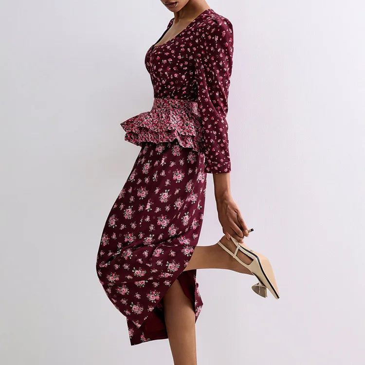 Woman wearing a burgundy floral dress with a plain background