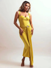 Woman wearing a yellow dress with a belt on a white background