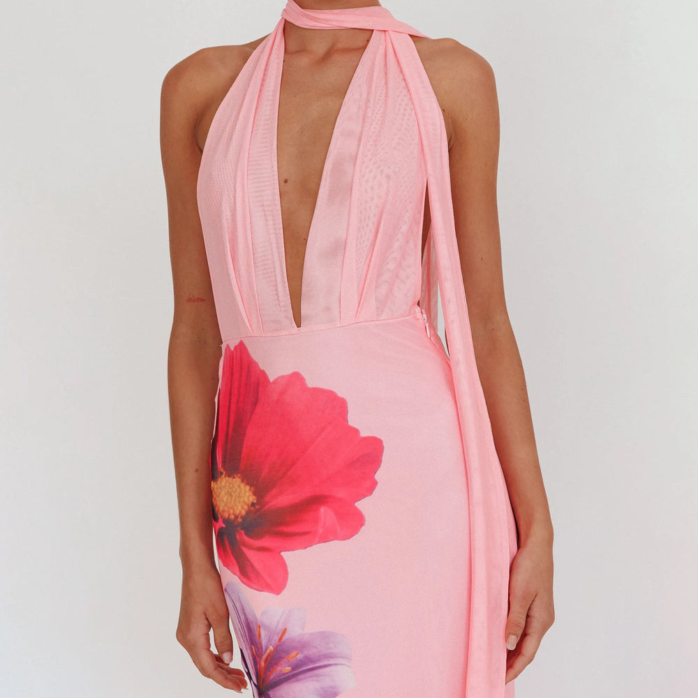 Pink halter neck dress with floral design on a white background