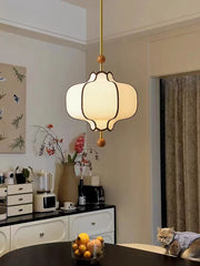Modern kitchen with pendant light, countertop items, and a cat on the floor.