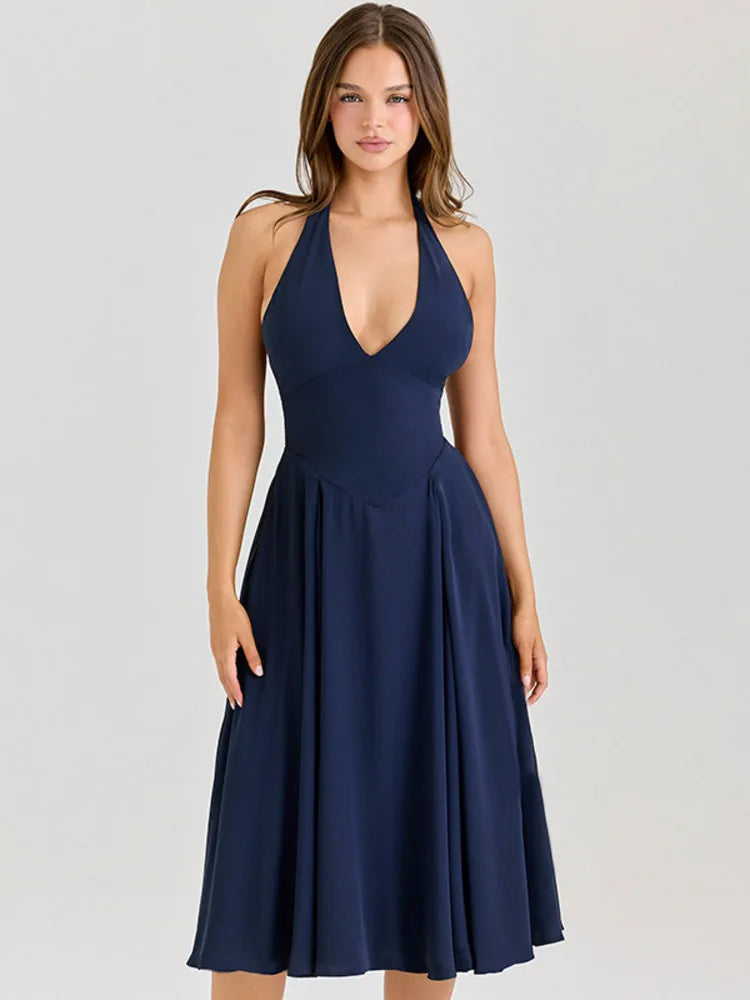 Navy blue halter neck dress on a model against a light gray background