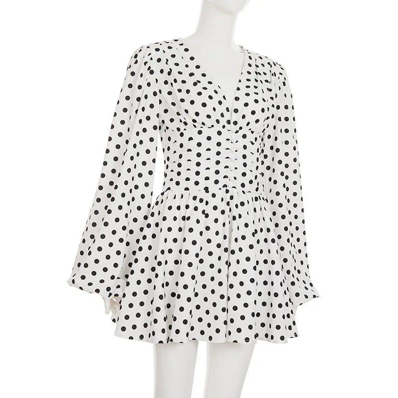 White dress with black polka dots on a mannequin against a white background
