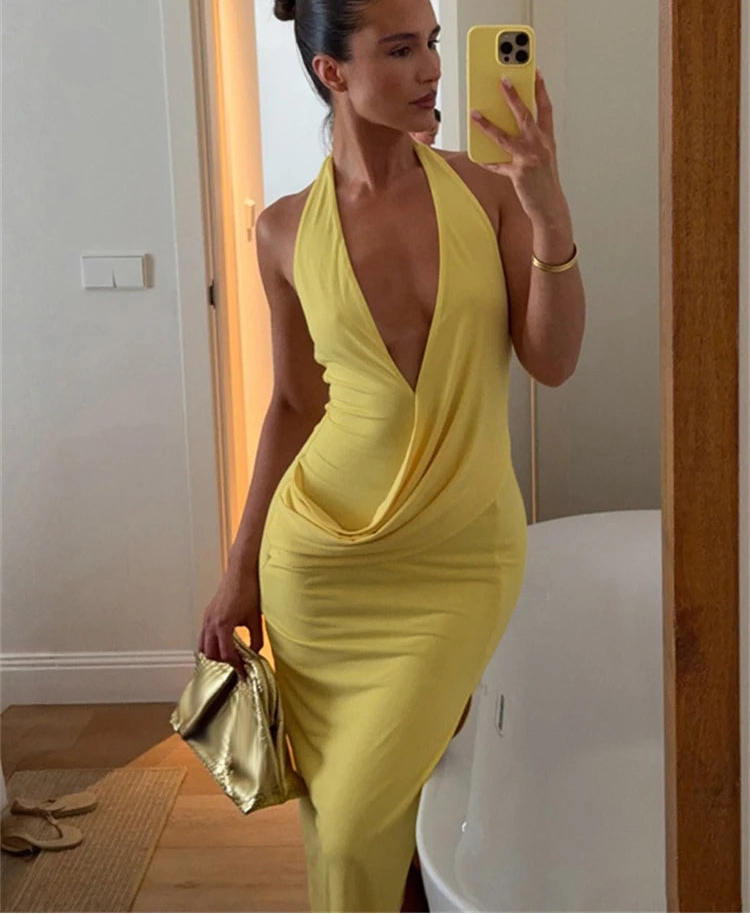 Close-up of yellow halter neck ruched maxi dress