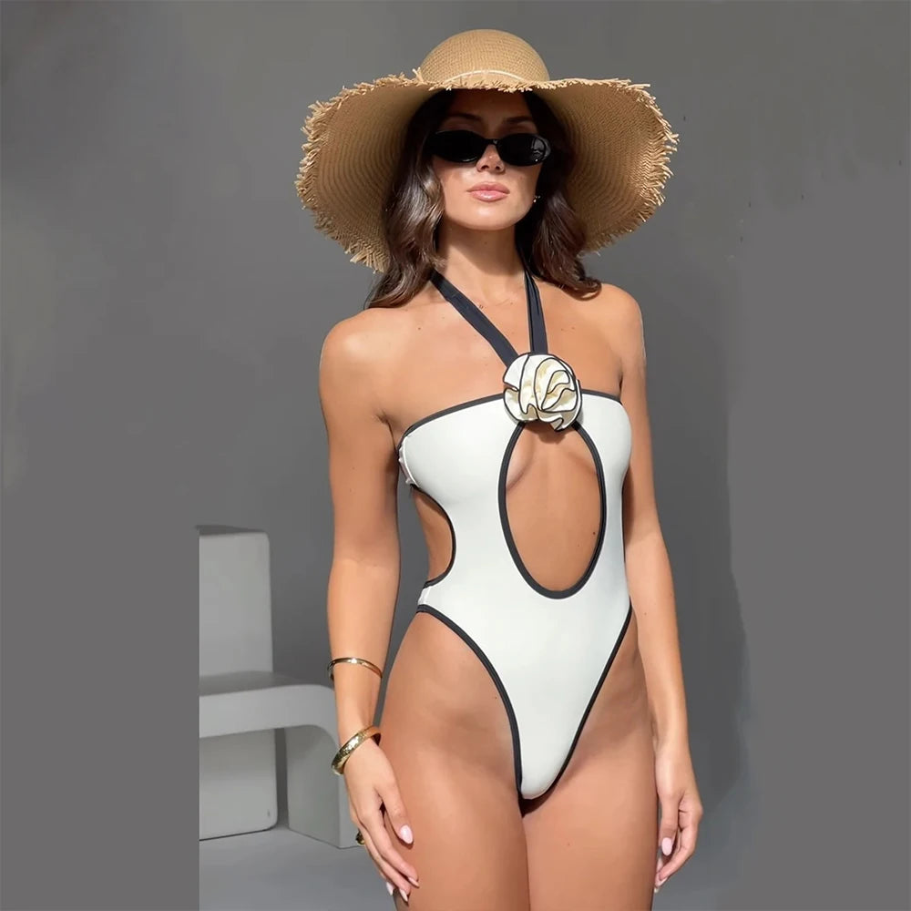 Model wearing a white one-piece swimsuit with hat and sunglasses