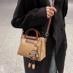 A woman carrying the shoulder bag, demonstrating its comfortable fit and stylish appeal.