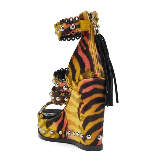 Side view of tiger print wedge platform sandals with metallic studs
