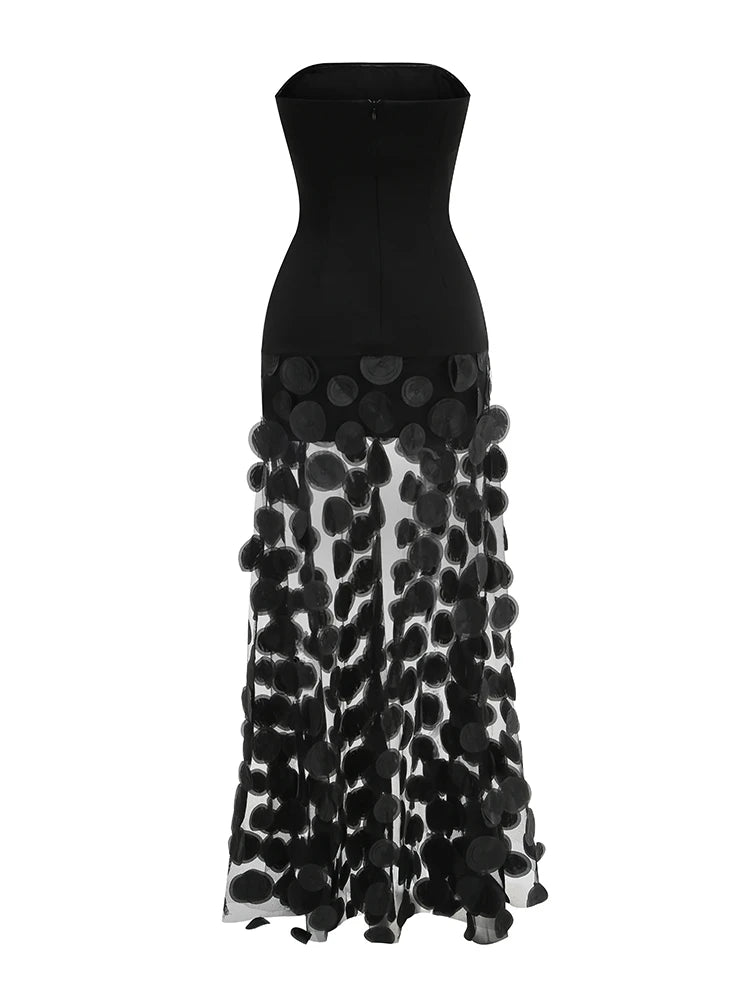 Black strapless dress with a patterned skirt on a white background