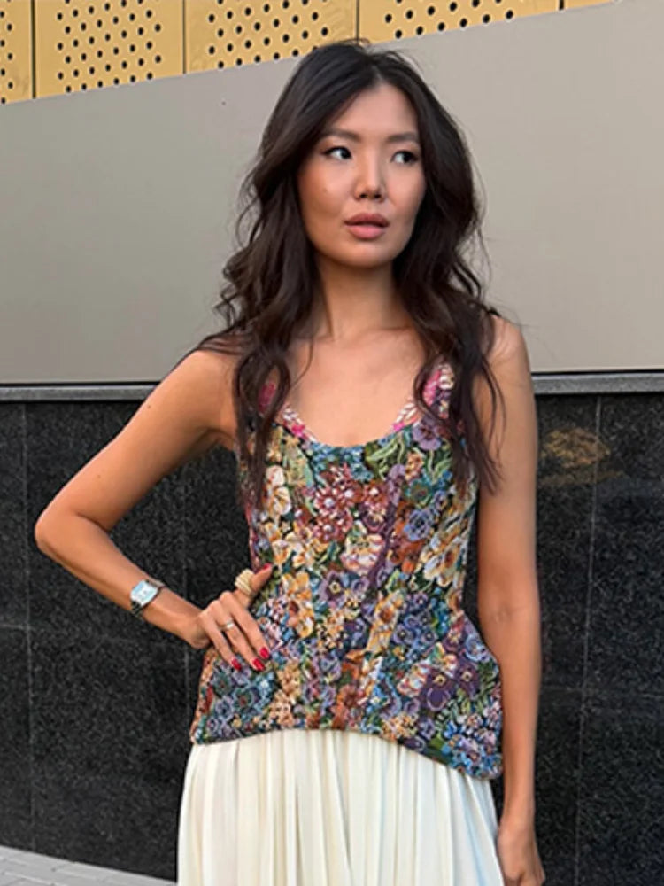 Close-up of a woman wearing a floral print peplum top and white maxi skirt