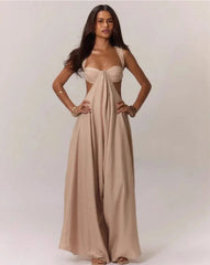 Woman wearing a beige jumpsuit on a plain background