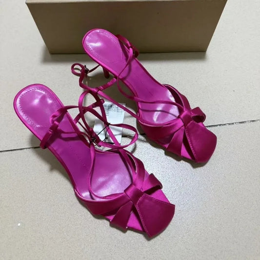 Pink satin stiletto heel with bow detail and ankle strap