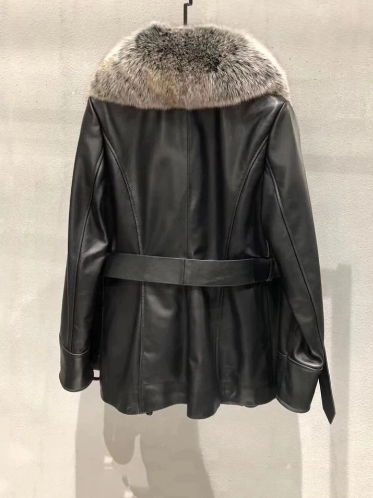 Black leather jacket with fur hood on a neutral background